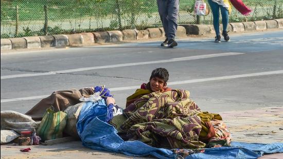 A homeless person braces the cold wave in New Delhi on Saturday. (PTI)