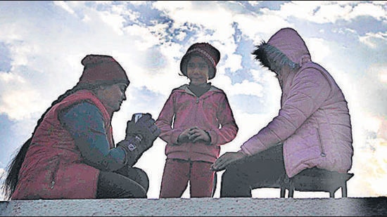 Residents warming up in Sector 34, Chandigarh, on a cold Monday morning. (Keshav Singh/HT)