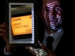 Aguttes auction house head of development Maximilien Aguttes holds a non-fungible token (NFT), replica of the original communication protocol that transmitted the first SMS text message ever sent, before its auction by Britain's Vodafone, in Neuilly-sur-Seine, near Paris, France