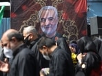 A poster of the late Iran's Quds Force top commander Qassem Soleimani is seen while Iranian people commemorate Arbaeen in Tehran, Iran