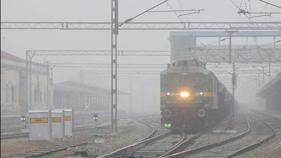 A train arrives at a railway station amid dense fog in Patiala on December 18, 2021. (PTI)