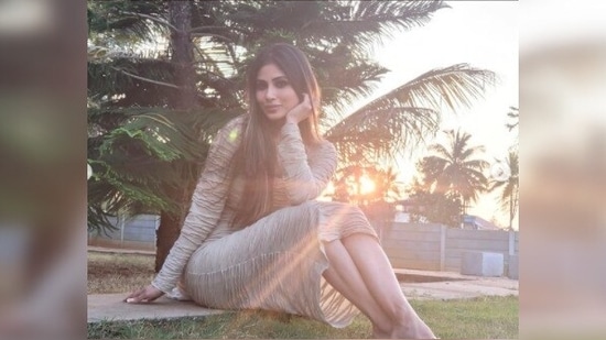 Mouni Roy teamed her long textured body-fitted neutral dress with a cape of the same shade.(Instagram/@imouniroy)