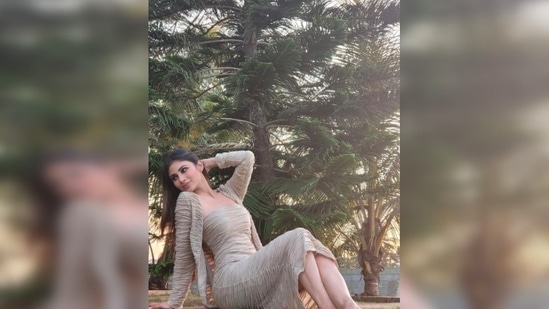 The Bengali beauty flaunts her curves as she strikes poses on the grass.(Instagram/@imouniroy)