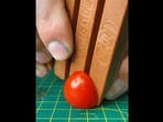 The tomato being cut by a sharpened KitKat bar. (instagram/@whathowhystudio) The tomato being cut by a sharpened KitKat bar. (instagram/@whathowhystudio)