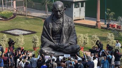 Opposition leaders read the Preamble to the Constitution of India, and recite the national anthem before the Mahatma Gandhi statue in Parliament on Wednesday. (PTI)