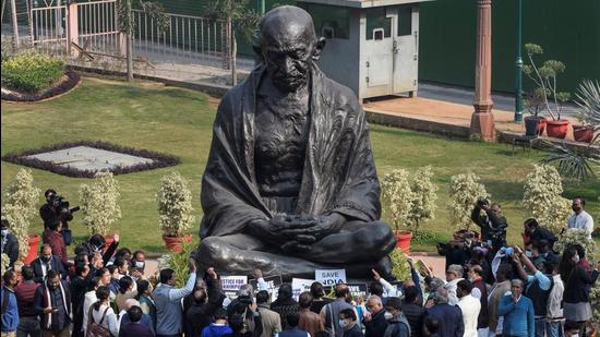 Opposition leaders, including the leader of Opposition Rajya Sabha, Mallikarjun Kharge, along with suspended MPs, read the Preamble to the Constitution and recite the national anthem before the Mahatma Gandhi statue in Parliament to protest the suspension of 12 lawmakers, in New Delhi on Wednesday. (PTI)