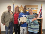 The image shows the man and the elderly woman along with others.