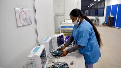 A staff member checks the functioning of the health monitoring equipment, at Commonwealth Games (CWG) Village isolation centre in view of rising Omicron cases, in New Delhi on Thursday. (ANI) A staff member checks the functioning of the health monitoring equipment, at Commonwealth Games (CWG) Village isolation centre in view of rising Omicron cases, in New Delhi on Thursday. (ANI)
