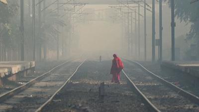 A woman crosses railway tracks on a smoggy morning in New Delhi this week. (HT photo) A woman crosses railway tracks on a smoggy morning in New Delhi this week. (HT photo)