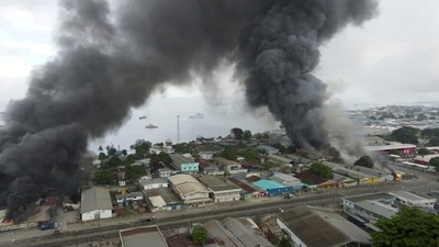 Smoke rises above buildings after days of unrest in Honiara, Solomon Islands (JONE TUIIPELEHAKI via REUTERS)