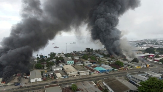 Smoke rises above buildings after days of unrest in Honiara, Solomon Islands(JONE TUIIPELEHAKI via REUTERS)