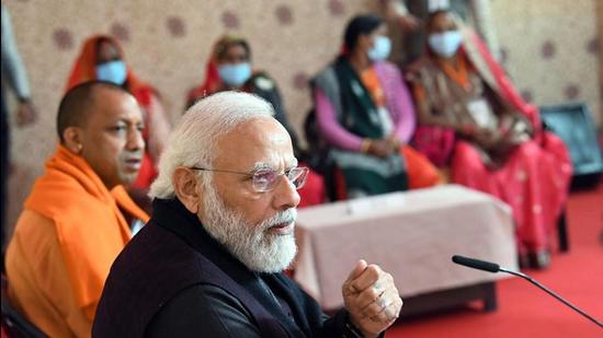 Prime Minister Narendra Modi at an interaction in Varanasi on Thursday. Uttar Pradesh chief minister Yogi Adityanath is also seen. (ANI PHOTO)