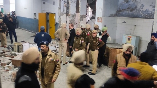 Police personnel inspect the blast site in Ludhiana on Thursday.