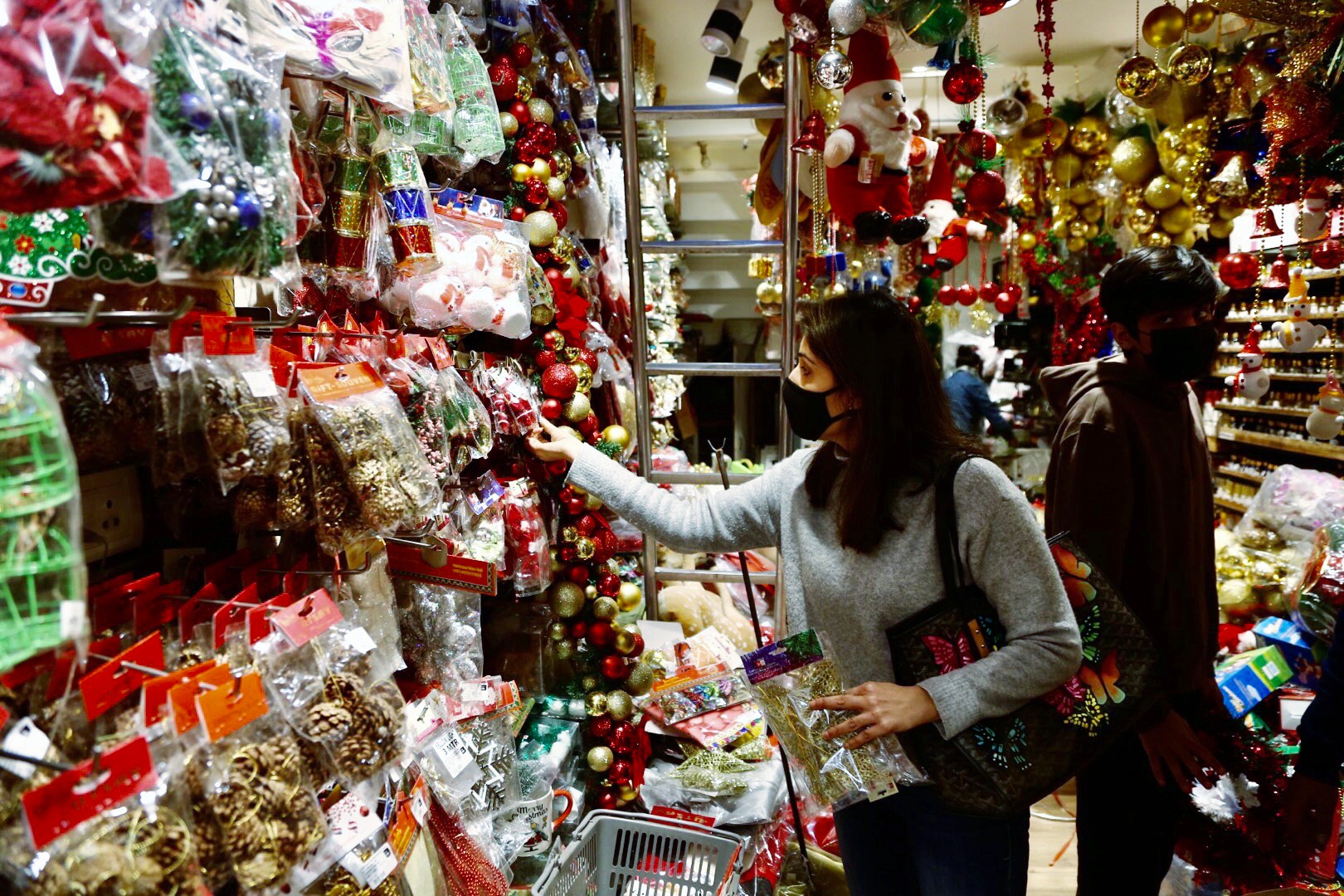 A woman purchases decorative items ahead of the Christmas festival at Khan Market, in New Delhi on December 22, 2021. (ANI photo) A woman purchases decorative items ahead of the Christmas festival at Khan Market, in New Delhi on December 22, 2021. (ANI photo)