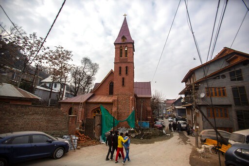 People walk past the St. Lukes Church in Srinagar ahead of its opening, on Wednesday. (AP Photo)
