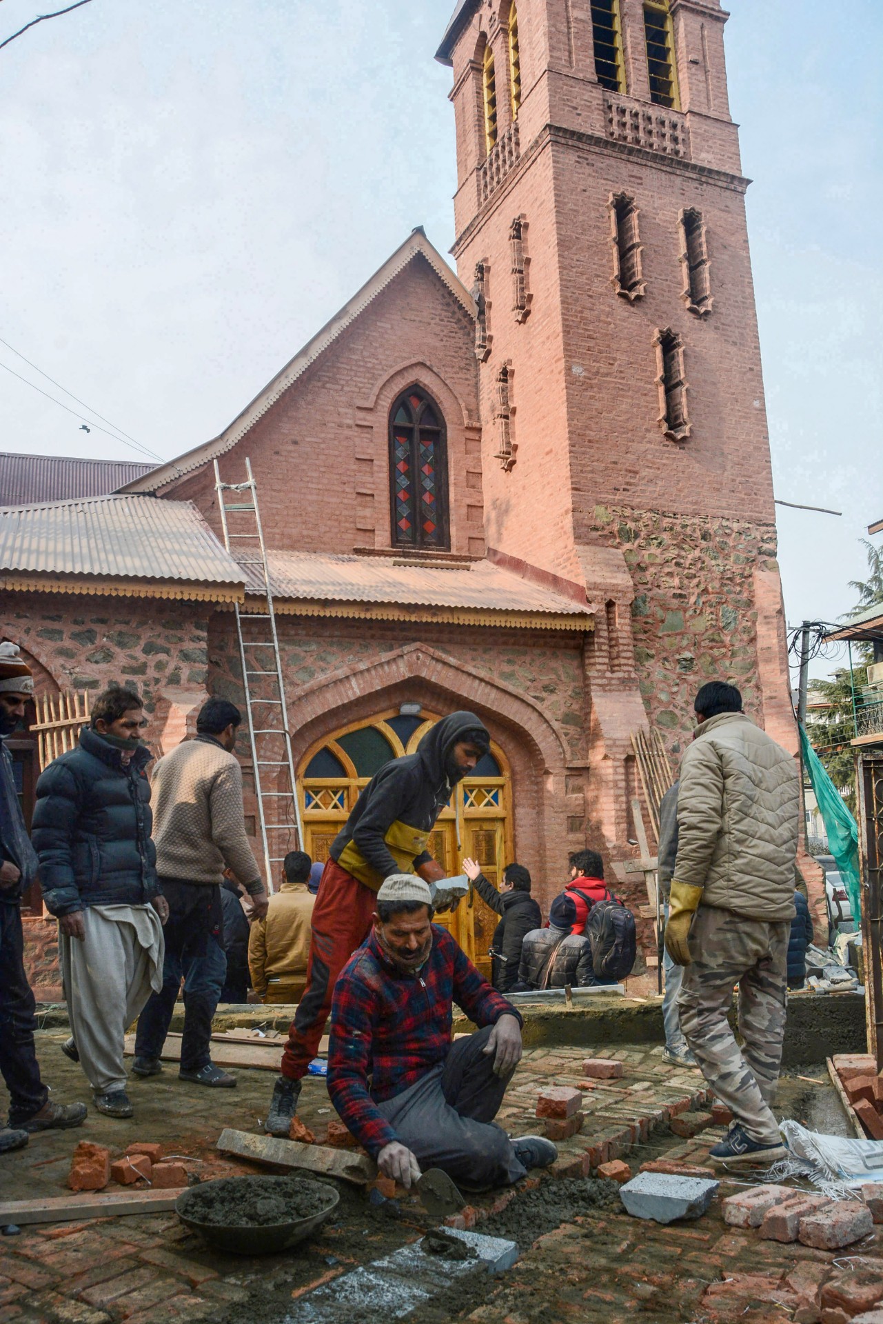 Labourers engaged in the restoration work at Saint Lukes Church. (PTI Photo)