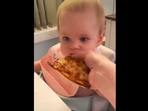 The adorable baby girl trying her first bite of a pizza. (instagram/@oh_shoot_girl) The adorable baby girl trying her first bite of a pizza. (instagram/@oh_shoot_girl)