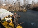 A boatman shows a piece of ice picked up from the partially frozen lake water in the interiors of Dal Lake in Srinagar, Jammu and Kashmir, A boatman shows a piece of ice picked up from the partially frozen lake water in the interiors of Dal Lake in Srinagar, Jammu and Kashmir, 