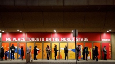 People queue up for their Covid-19 vaccine booster shots at a clinic inside the Metro Toronto Convention Centre, as the latest Omicron variant emerges as a threat, in Toronto, Ontario, Canada. (REUTERS) (HT_PRINT) People queue up for their Covid-19 vaccine booster shots at a clinic inside the Metro Toronto Convention Centre, as the latest Omicron variant emerges as a threat, in Toronto, Ontario, Canada. (REUTERS) (HT_PRINT)