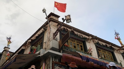 The indoctrination is also aimed at overcoming resistance within the local population to the People’s Liberation Army’s (PLA) efforts to recruit more Tibetans. In picture - A Chinese flag flutters above surveillance cameras in Lhasa, Tibet. (Reuters )