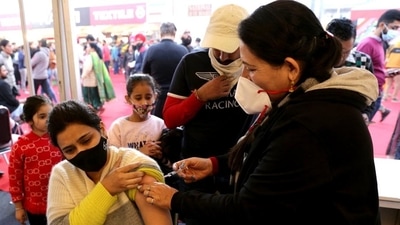 A health care worker inoculates a beneficiary with a dose of the Covid-19 vaccine. (ANI)