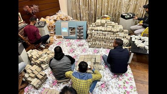 Income Tax department unearthed almost <span class='webrupee'>₹</span>150 crore in cash in a tax raid at businessman Piyush Jain’s residence, in Kanpur on Friday. The cash bundles were all wrapped in paper covers and secured with yellow tape. (ANI Photo) Income Tax department unearthed almost <span class='webrupee'>₹</span>150 crore in cash in a tax raid at businessman Piyush Jain’s residence, in Kanpur on Friday. The cash bundles were all wrapped in paper covers and secured with yellow tape. (ANI Photo)