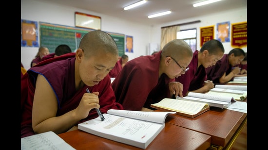 Tibetan Buddhist nuns read from their textbooks as they attend a Chinese language class at the Tibetan Buddhist College near Lhasa in western China's Tibet Autonomous Region. China is launching an aggressive campaign to promote Mandarin, saying 85% of its citizens will use the national language by 2025. (AP/File Photo)