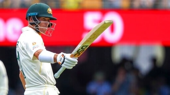 Australia's David Warner celebrates after scoring 50 runs during day two of the first Ashes cricket test at the Gabba in Brisbane, Australia, Thursday. (AP)