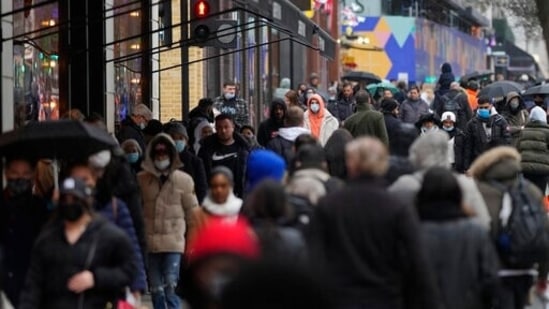 The UKHSA said the reduction in risk “is likely to be partly a reduction in intrinsic severity of the virus and partly to protection provided by prior infection”. In picture - Shoppers wear face mask on Oxford Street in London.(AP)