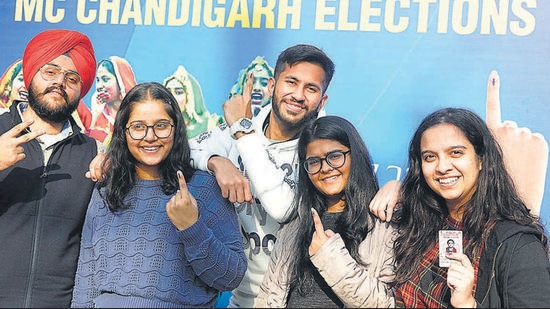 Elated first-time voters posing in front of the selfie zone at Saupin’s School in Sector 32, Chandigarh, on Friday. (Keshav Singh/HT)