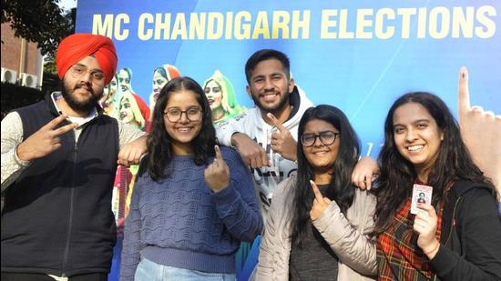 First-time voters after exercising their franchise in front of the selfie zone set up by the Chandigarh Administration in Sector 32 on Friday. Polling was held peacefully for 35 municipal corporation seats. (Keshav Singh/HT)