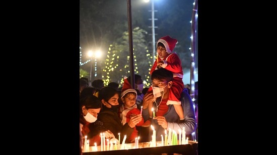 Residents light candles at the church in Sector 19, Chandigarh on the occasion of Christmas on Saturday. (Ravi Kumar/HT)