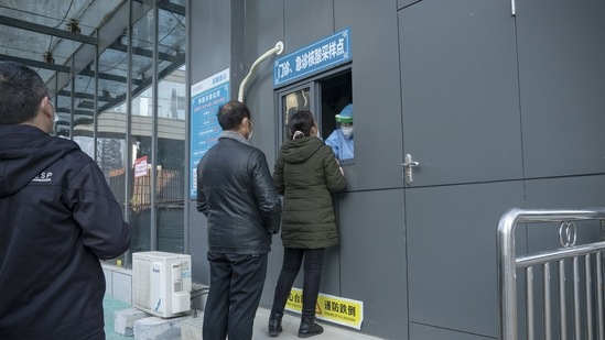 Members of the public wait in line to take a swab for a Covid-19 PCR test outside a hospital in Wuhan, Hubei Province, China.(Bloomberg) Members of the public wait in line to take a swab for a Covid-19 PCR test outside a hospital in Wuhan, Hubei Province, China.(Bloomberg)