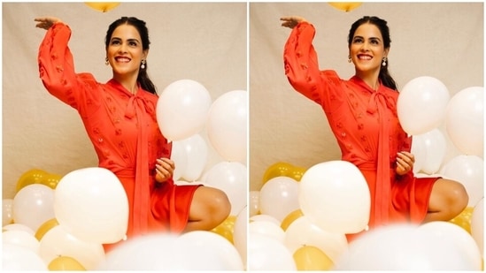 Genelia wore a trendy red blouse featuring long bishop sleeves with gathered cuffs, sequinned embroidery, a long ribbon tie on the neckline, and a loose silhouette. The star wore the top by tucking it inside her bottoms.(Instagram/@geneliad)