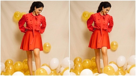 Genelia teamed the blouse with a matching bright red pleated skirt and accessorised the all-red look with pearl and stone-adorned drop earrings. Her centre-parted messy ponytail added a playful touch to the Christmas look.(Instagram/@geneliad)