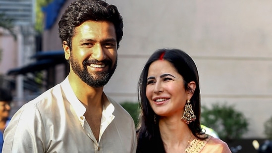 Vicky Kaushal and Katrina Kaif pose for photographs outside an airport upon their return, in Mumbai. (PTI)(PTI)