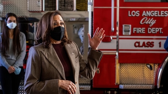 Vice President Kamala Harris, wearing a face mask speaks, with firefighters while visiting the Los Angeles Fire Department Station on Friday.(AP Photo)