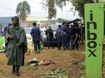 Police officers inspect the scene of a bombed explosion in Beni, eastern Congo.