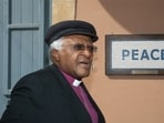 In this file photo taken on October 09, 2008, South African cleric and anti-apartheid campaigner Desmond Tutu walks past a street mosaic that reads 'Peace' on the green line that separates the Greek Cypriot side from the Turkish military-controlled areas in the heart of Nicosia. (AFP)