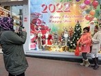 Iranians pose for a picture in front of a shop selling Christmas decorations in the capital Tehran (Photo by AFP)