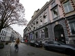 A man rides his bike past a cinema with Christmas trees hanging upside down from the windows in protest against the closure of cultural venues in Antwerp, Belgium, (AP Photo/Virginia Mayo) A man rides his bike past a cinema with Christmas trees hanging upside down from the windows in protest against the closure of cultural venues in Antwerp, Belgium, (AP Photo/Virginia Mayo)