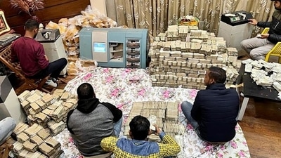 Income Tax department unearthed crores of money in cash in a tax raid at businessman Piyush Jain’s residence, in Kanpur on Friday. The cash bundles were all wrapped in paper covers and secured with yellow tape. Income Tax department unearthed crores of money in cash in a tax raid at businessman Piyush Jain’s residence, in Kanpur on Friday. The cash bundles were all wrapped in paper covers and secured with yellow tape. 