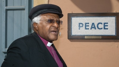 In this file photo taken on October 09, 2008, South African cleric and anti-apartheid campaigner Desmond Tutu walks past a street mosaic that reads 'Peace' on the green line that separates the Greek Cypriot side from the Turkish military-controlled areas in the heart of Nicosia. (AFP) In this file photo taken on October 09, 2008, South African cleric and anti-apartheid campaigner Desmond Tutu walks past a street mosaic that reads 'Peace' on the green line that separates the Greek Cypriot side from the Turkish military-controlled areas in the heart of Nicosia. (AFP)