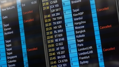 An information panel showing flight cancellations in the departure hall at Hong Kong International Airport in Hong Kong, China. Airlines face a return to the uncertainty of shifting rules and public-health developments that threw customer plans into chaos and undermined demand earlier in the pandemic. (Photographer: Chan Long Hei/Bloomberg) An information panel showing flight cancellations in the departure hall at Hong Kong International Airport in Hong Kong, China. Airlines face a return to the uncertainty of shifting rules and public-health developments that threw customer plans into chaos and undermined demand earlier in the pandemic. (Photographer: Chan Long Hei/Bloomberg)
