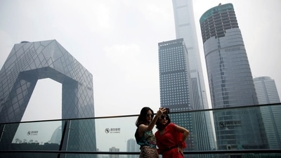Women pose for pictures at a shopping mall near the CCTV headquarters and China Zun skyscraper in Beijing's central business district (CBD), China, July 16, 2020.&nbsp; (File Photo / REUTERS)