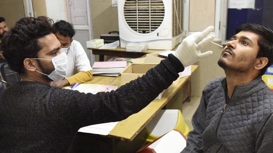 A health worker collects a swab sample of a man for Covid-19 test in Ghaziabad on Saturday. (Sakib Ali/HT photo) A health worker collects a swab sample of a man for Covid-19 test in Ghaziabad on Saturday. (Sakib Ali/HT photo)