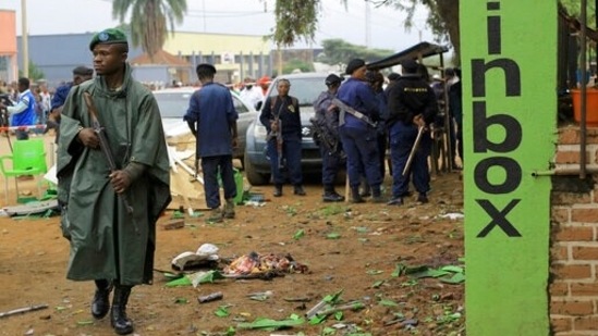 Police officers inspect the scene of a bombed explosion in Beni, eastern Congo.(AP)