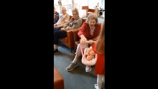 The image, taken from the Instagram video, shows the girl gifting dolls to a dementia patient.(Instagram/@goodnews_movement)