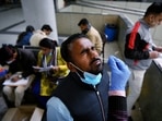 A healthcare worker takes a nasal swab sample of a passenger for the Covid-19 test, at Kashmere Gate ISBT, in view of rising Omicron cases, in New Delhi on Monday. A healthcare worker takes a nasal swab sample of a passenger for the Covid-19 test, at Kashmere Gate ISBT, in view of rising Omicron cases, in New Delhi on Monday. 