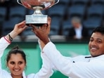 Sania Mirza and Mahesh Bhupathi of India pose with the winners trophy after defeating Klaudia Jans-Ignacik of Poland and Santiago Gonzalez of Mexico in the mixed doubles final of French Open.